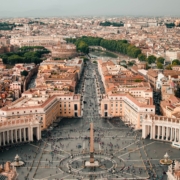 Italy Aerial view of St. Peter's Square in Vatican City, showing the central obelisk, surrounding colonnades, and a crowded plaza below.